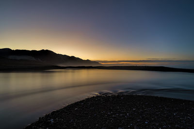 Scenic view of lake against sky during sunset