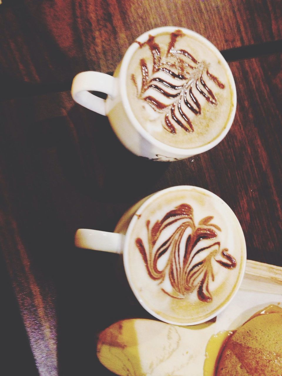 food and drink, coffee cup, drink, table, saucer, refreshment, indoors, coffee - drink, freshness, frothy drink, cappuccino, coffee, still life, froth art, cup, spoon, high angle view, latte, close-up, beverage