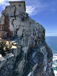 Rock formation in sea against sky at cape point 