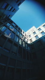 Low angle view of modern building against blue sky