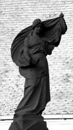 Low angle view of statue against wall