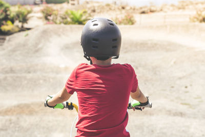 Rear view of boy riding bicycle at sports ramp