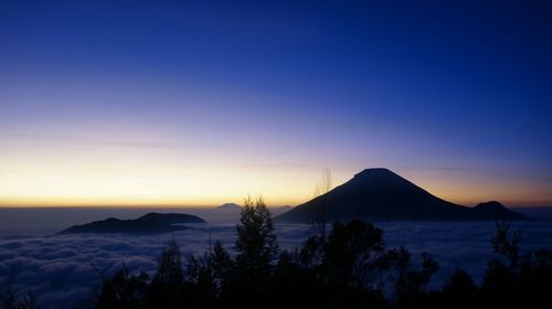 Scenic view of silhouette mountains against sky at sunset