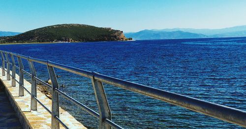 Scenic view of sea against clear blue sky