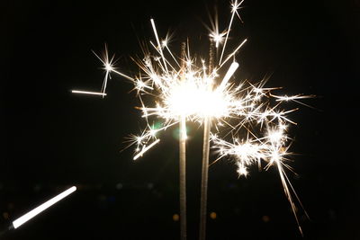 Low angle view of firework display at night