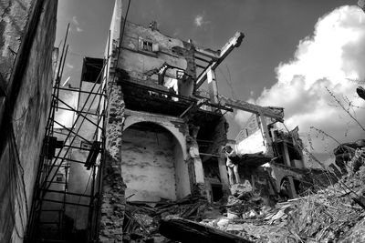 Low angle view of abandoned built structure against sky