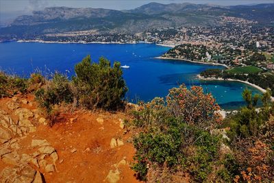 High angle view of lake and cityscape against sky