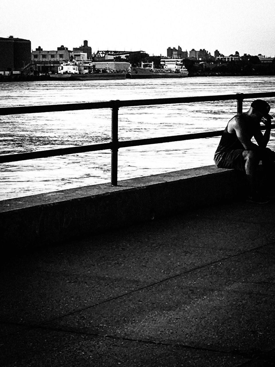 water, architecture, built structure, building exterior, sea, river, transportation, bridge - man made structure, railing, sky, city, connection, incidental people, outdoors, bicycle, mode of transport, clear sky, pier, bridge, day