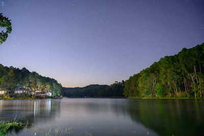 Scenic view of lake against sky at night