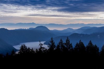 Scenic view of silhouette mountains against sky at sunset
