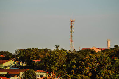 Low angle view of trees and buildings against sky