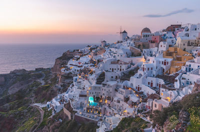 High angle view of townscape by sea against sky