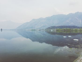 Scenic view of lake against cloudy sky