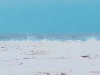 Surface level of beach against clear sky