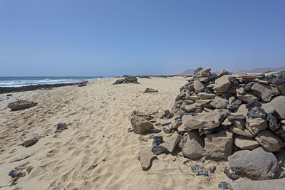 Scenic view of beach against clear sky