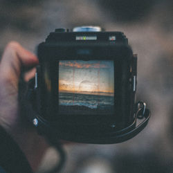 Close-up of person photographing camera