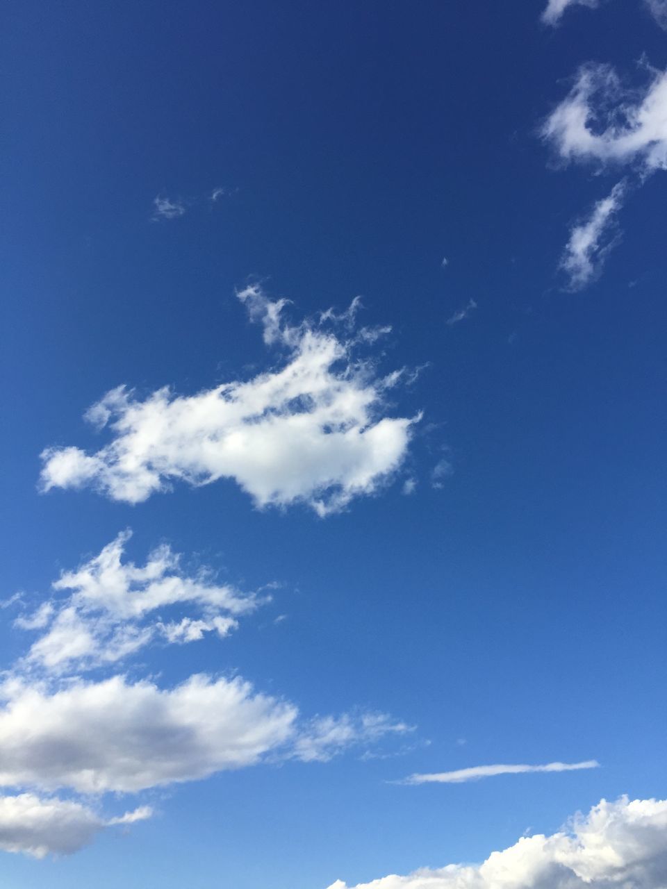 blue, sky, low angle view, cloud - sky, beauty in nature, tranquility, cloud, scenics, nature, tranquil scene, white color, day, sky only, outdoors, idyllic, cloudy, no people, cloudscape, sunlight, white