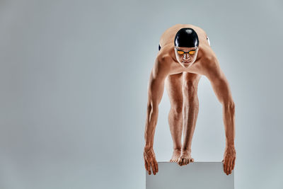 Full length of swimmer against white background