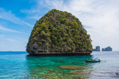 Scenic view of rock formation in sea against sky