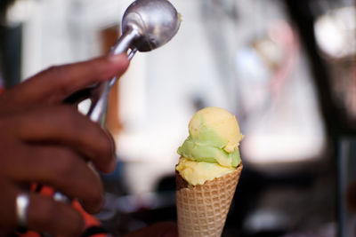 Close-up of hand holding ice cream