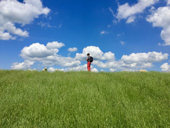 Low angle view of man standing on land against sky