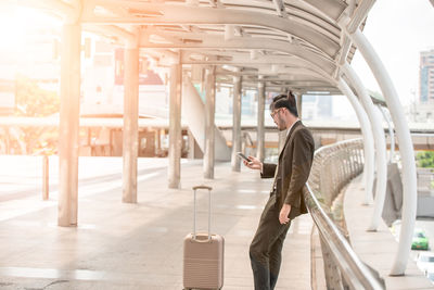 Side view of man walking on escalator