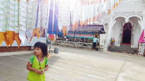 Girl standing in front of building