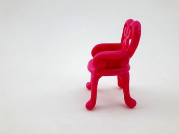 Close-up of red toy against white background