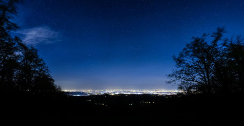 Low angle view of star field against blue sky