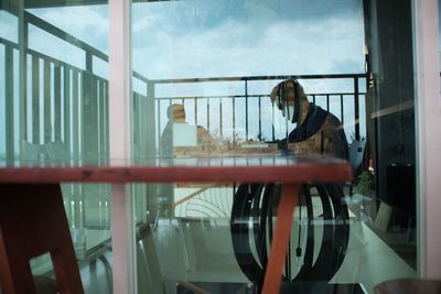 Reflection of woman on glass window