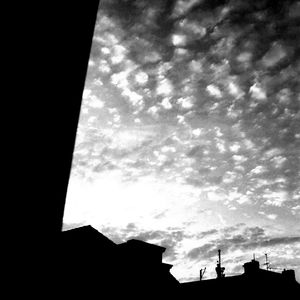 Low angle view of building against cloudy sky