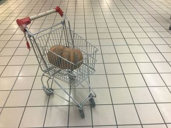 High angle view of bird in basket on floor