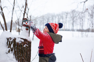 Low section of woman holding christmas tree