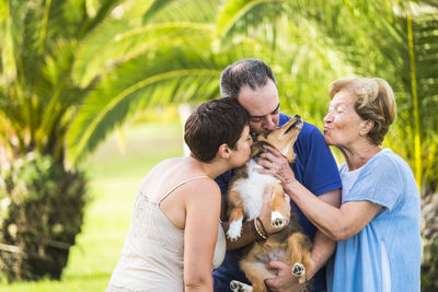 People kissing dog