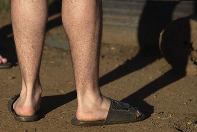 Low section of man standing on footpath