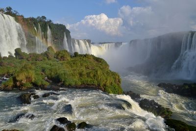 Scenic view of waterfall with rainbow