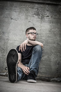 Portrait of man sitting on floor