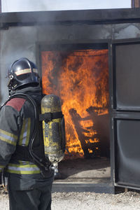 Side view of firefighter working outdoors