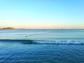 Scenic view of sea against clear blue sky