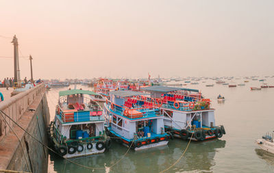 Boats stationed at the harbor at gateway of india in mumbai