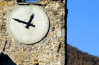 Low angle view of clock tower against clear sky