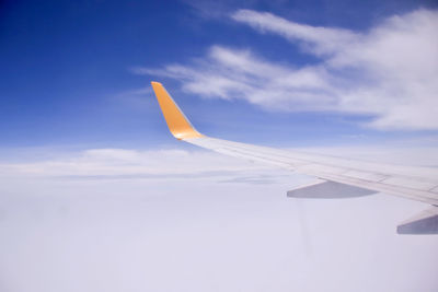 Airplane wing against sky