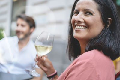 Portrait of a smiling woman holding drink