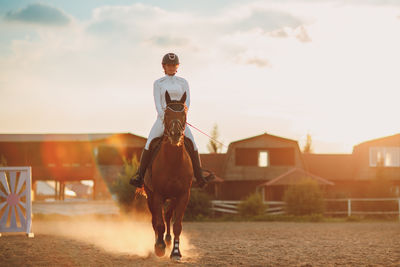 Rear view of woman standing on road