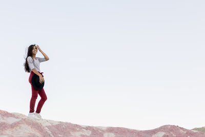 Full length of woman standing against mountain