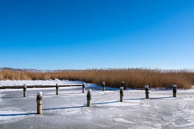 Scenic view of snow covered field against clear sky