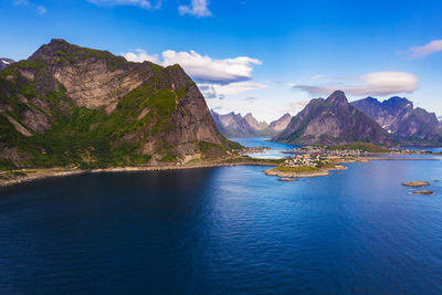 Scenic view of sea and mountains against sky