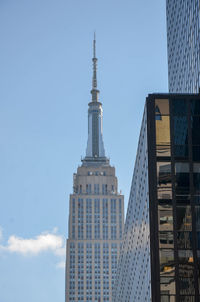 Low angle view of the empire state building against sky.