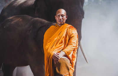 Portrait of man standing on sculpture