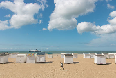 Sandy beach of calais in summer with its beach cabins and view of the english channel